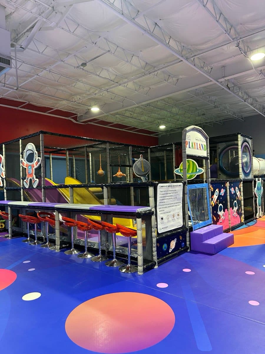 Wide view of D&R Playland Brooklyn facility with space-themed floor