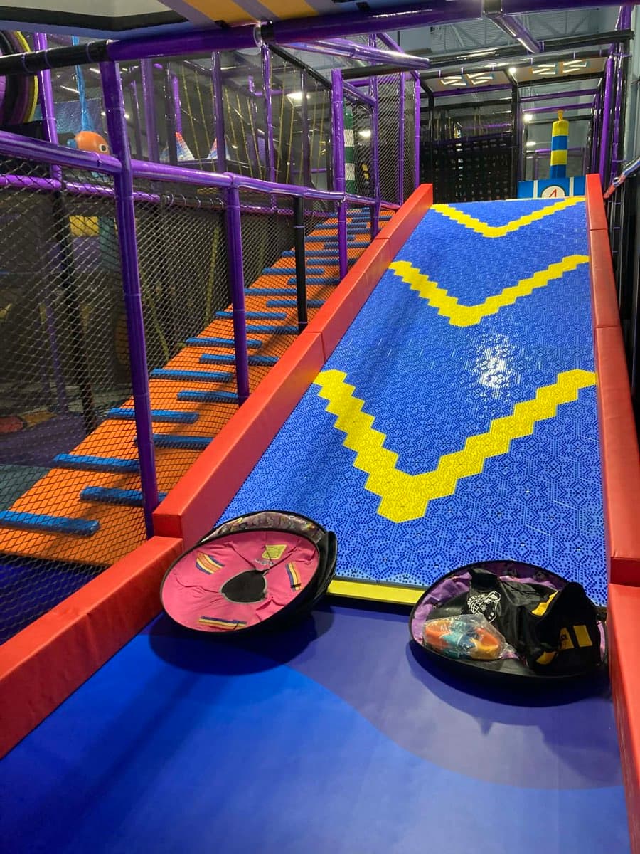 Donut slide from wider angle showing tubes and play structure at Sheffield Village